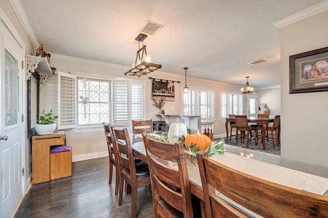 dining area featuring a chandelier, a textured ceiling, crown molding, and dark wood-type flooring