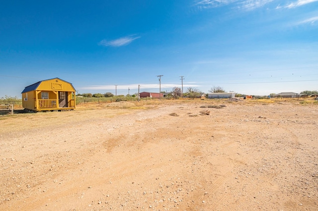 view of yard featuring a rural view and an outdoor structure