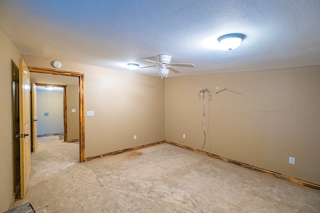 unfurnished room featuring ceiling fan and a textured ceiling