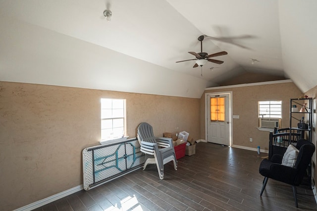 living area with cooling unit, dark hardwood / wood-style floors, ceiling fan, and vaulted ceiling