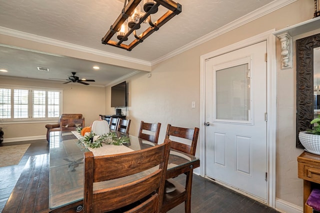 dining room featuring a textured ceiling, ceiling fan with notable chandelier, ornamental molding, and dark wood-type flooring