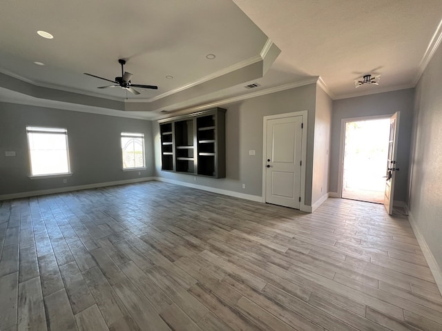 spare room featuring crown molding, ceiling fan, a tray ceiling, and hardwood / wood-style floors