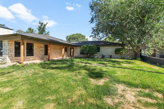 2208 Bedford Dr, Midland, TX 79701 - exterior space featuring stone siding, a chimney, and a yard