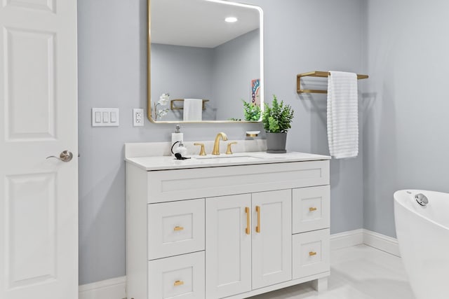 2208 Bedford Dr, Midland, TX 79701 - full bath with vanity, a freestanding tub, and baseboards