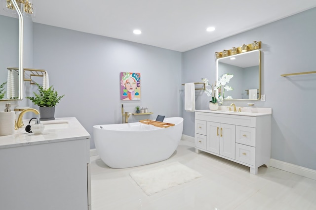2208 Bedford Dr, Midland, TX 79701 - bathroom with a freestanding tub, two vanities, baseboards, and a sink