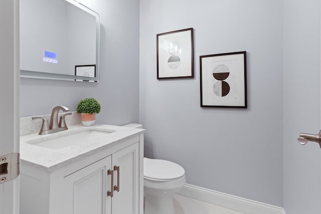 2208 Bedford Dr, Midland, TX 79701 - bathroom featuring toilet, vanity, and baseboards