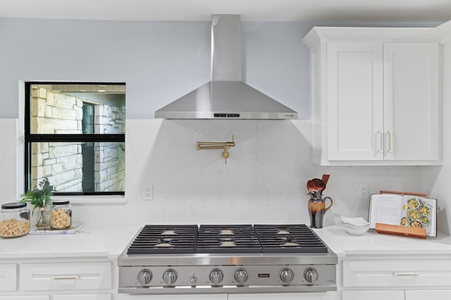 2208 Bedford Dr, Midland, TX 79701 - kitchen featuring white cabinetry, light countertops, wall chimney range hood, and range