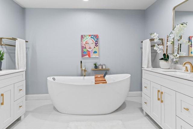 2208 Bedford Dr, Midland, TX 79701 - full bathroom featuring a freestanding bath, vanity, and baseboards
