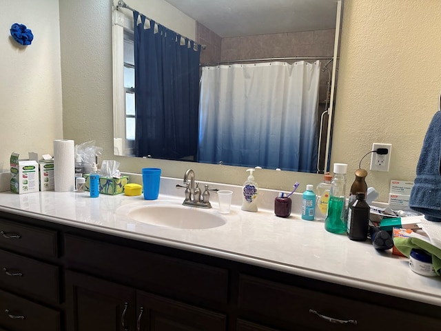 bathroom featuring a shower with curtain and vanity