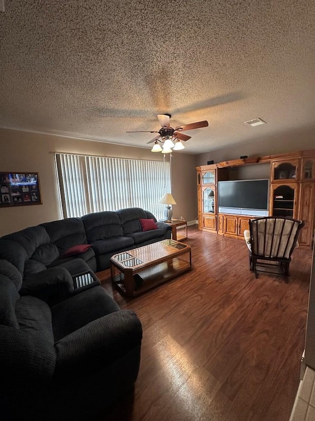 living room with ceiling fan, wood-type flooring, and a textured ceiling