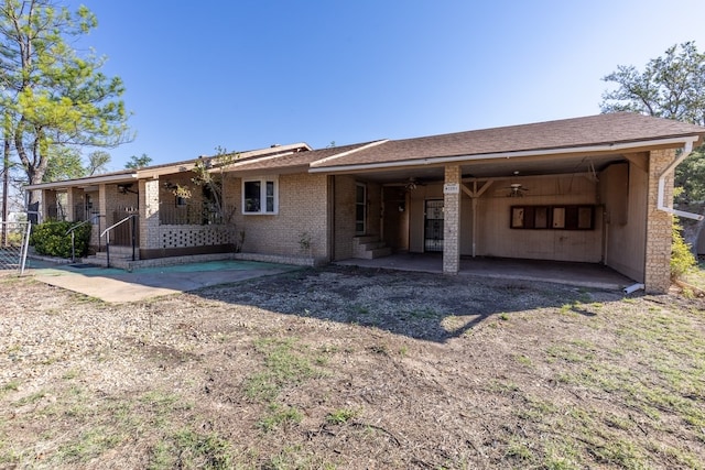 view of front of property with an attached carport and brick siding