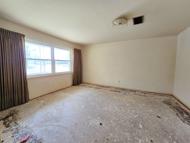 unfurnished room featuring visible vents