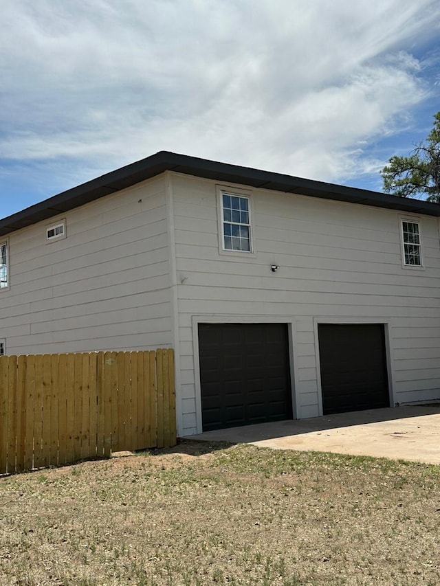 103 W Cowden Ave, Midland, TX 79701 - view of side of home with dirt driveway and an attached garage