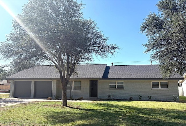 2612 Cimmaron Ave, Midland, TX 79705 - ranch-style house with a garage, a front lawn, driveway, brick siding, and roof with shingles