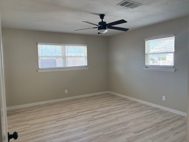 2612 Cimmaron Ave, Midland, TX 79705 - spare room featuring healthy amount of natural light, light wood-style flooring, a textured ceiling, and a ceiling fan