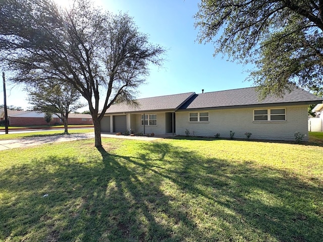 2612 Cimmaron Ave, Midland, TX 79705 - ranch-style house with an attached garage, driveway, a front lawn, and brick siding