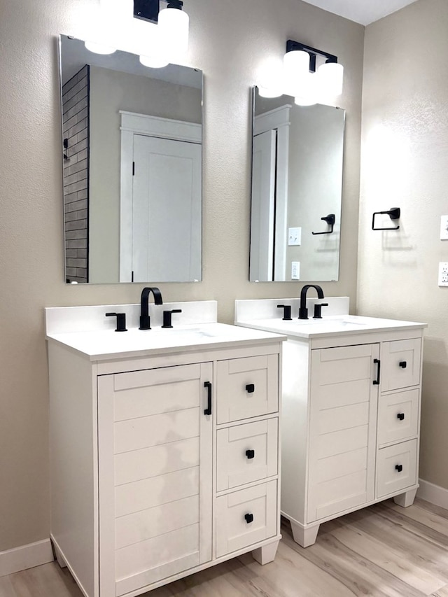 2612 Cimmaron Ave, Midland, TX 79705 - full bathroom featuring wood finished floors and two vanities