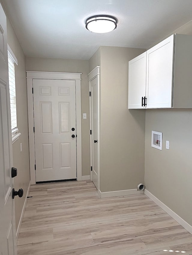 2612 Cimmaron Ave, Midland, TX 79705 - laundry room featuring light wood-style flooring, cabinet space, and hookup for a washing machine