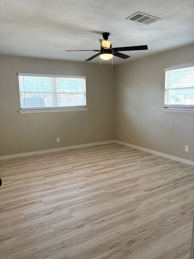 2612 Cimmaron Ave, Midland, TX 79705 - spare room featuring light wood-type flooring, a textured ceiling, and a ceiling fan