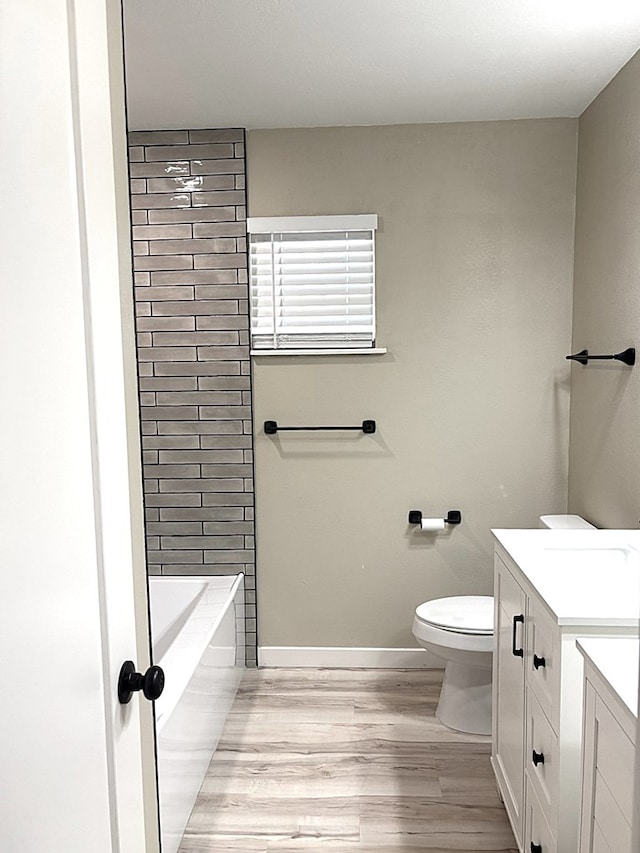 2612 Cimmaron Ave, Midland, TX 79705 - bathroom with vanity, wood finished floors, and washtub / shower combination