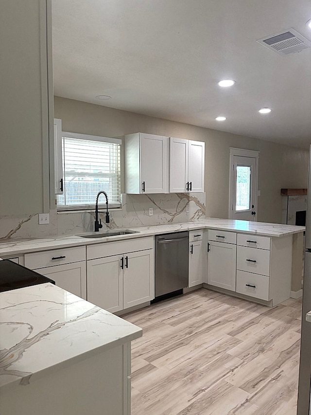 2612 Cimmaron Ave, Midland, TX 79705 - kitchen with dishwasher, a peninsula, recessed lighting, light stone counters, and light wood-style flooring