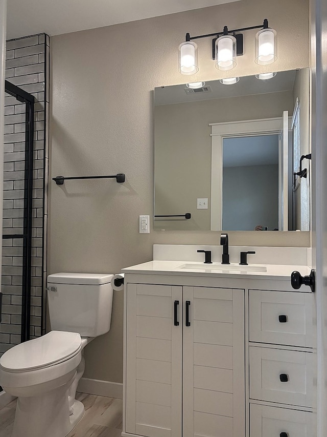2612 Cimmaron Ave, Midland, TX 79705 - full bathroom featuring a shower stall, vanity, and wood finished floors