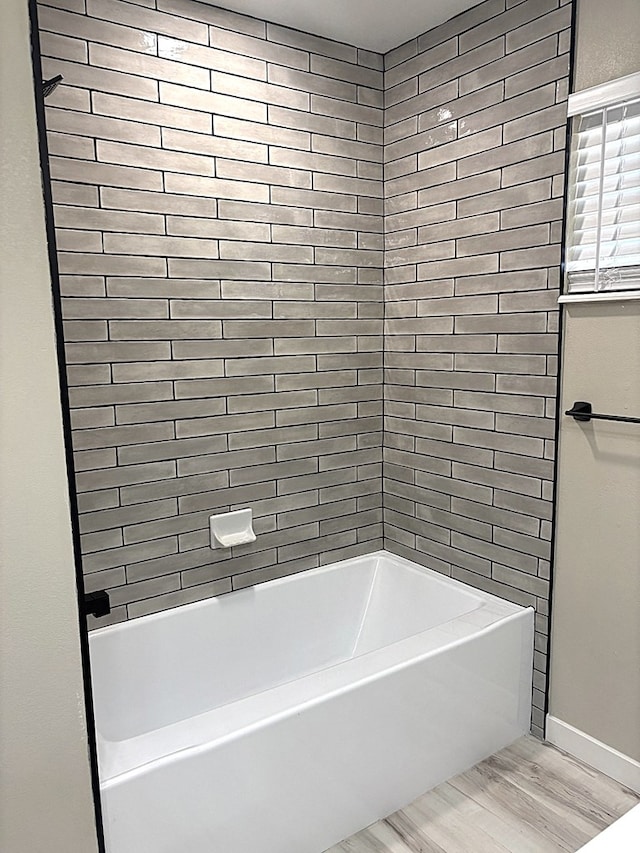 2612 Cimmaron Ave, Midland, TX 79705 - full bathroom featuring wood finished floors and shower / washtub combination
