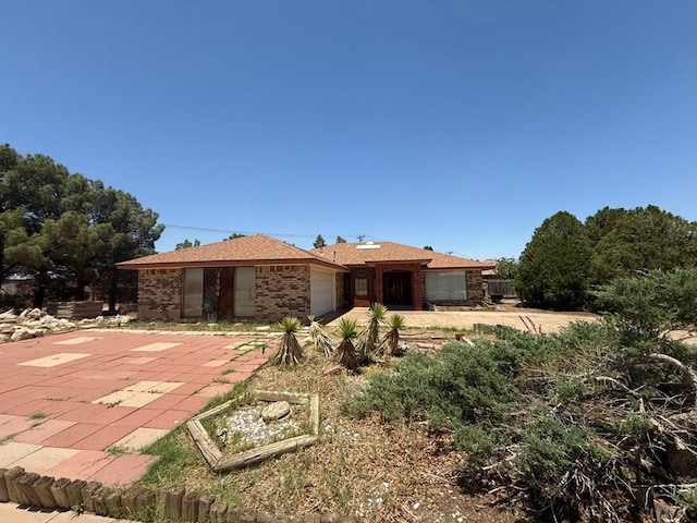 3804 Faircircle, Midland, TX 79707 - single story home featuring an attached garage, brick siding, and a patio area