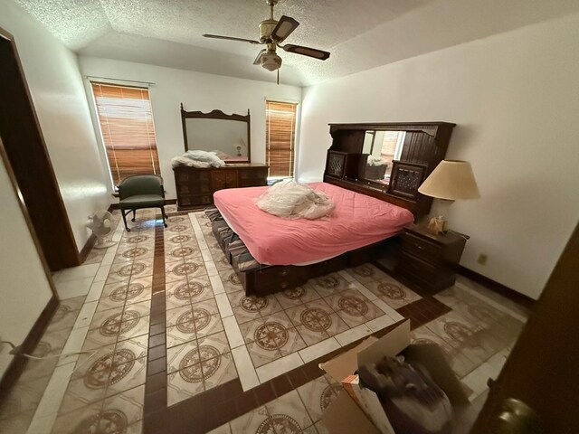 3804 Faircircle, Midland, TX 79707 - tiled bedroom with a textured ceiling, vaulted ceiling, and a ceiling fan