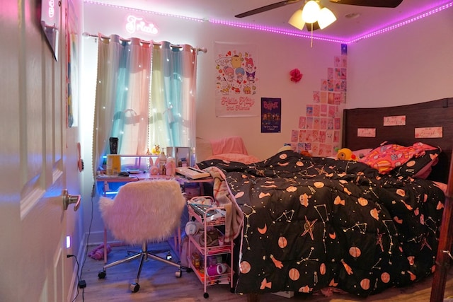 bedroom with ceiling fan and hardwood / wood-style floors