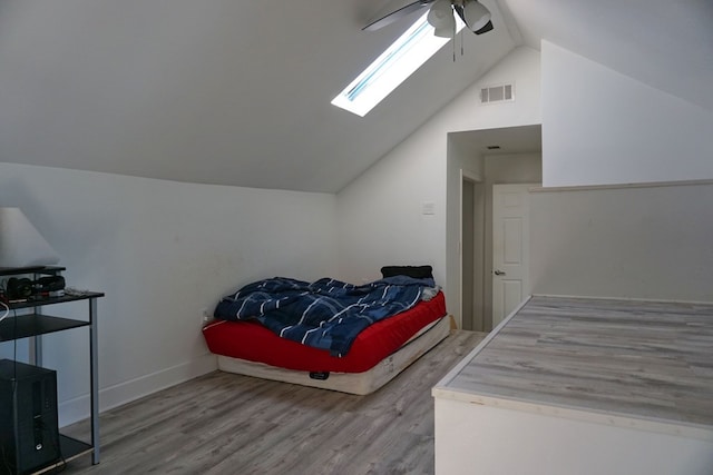 bedroom featuring vaulted ceiling, hardwood / wood-style floors, and ceiling fan