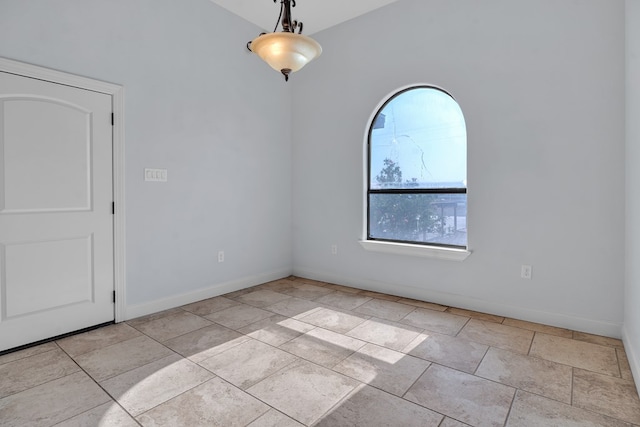 unfurnished room featuring baseboards