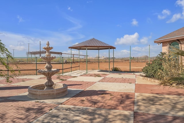 view of patio with a gazebo and fence