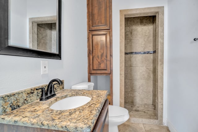 bathroom featuring toilet, a shower stall, tile patterned flooring, and vanity