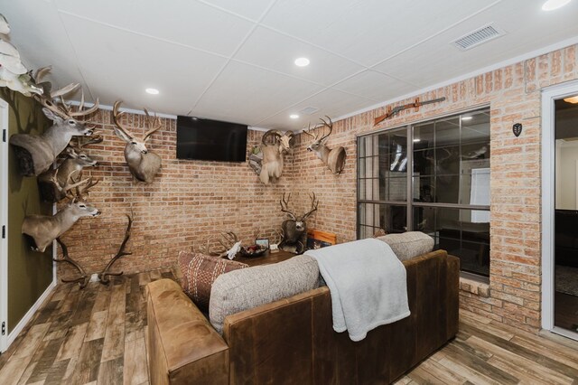 4902 Foxboro Ct, Midland, TX 79705 - living room with wood finished floors, recessed lighting, and brick wall