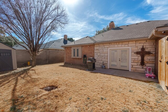 4902 Foxboro Ct, Midland, TX 79705 - back of house with french doors, a fenced backyard, a chimney, and a shingled roof