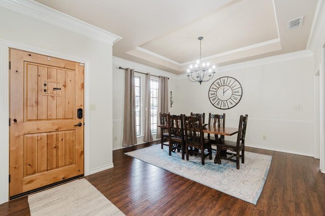 4902 Foxboro Ct, Midland, TX 79705 - dining space featuring a chandelier, dark wood-style floors, a raised ceiling, ornamental molding, and baseboards