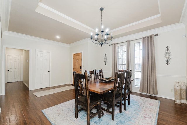 4902 Foxboro Ct, Midland, TX 79705 - dining area with a tray ceiling, a chandelier, dark wood finished floors, crown molding, and baseboards