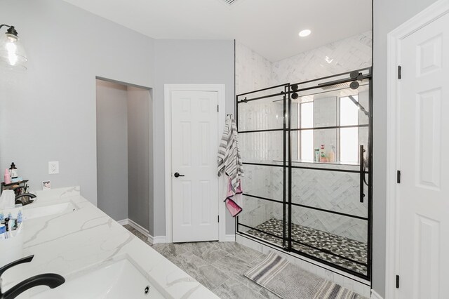 4902 Foxboro Ct, Midland, TX 79705 - full bathroom featuring a stall shower, marble look tiles, double vanity, and baseboards