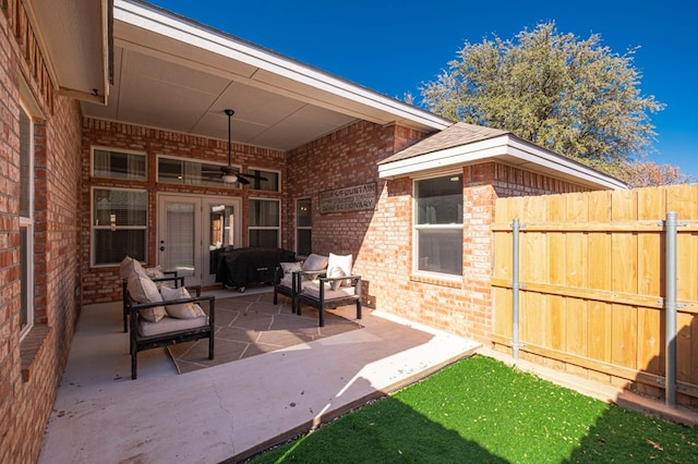 view of patio / terrace featuring ceiling fan, fence, and an outdoor living space