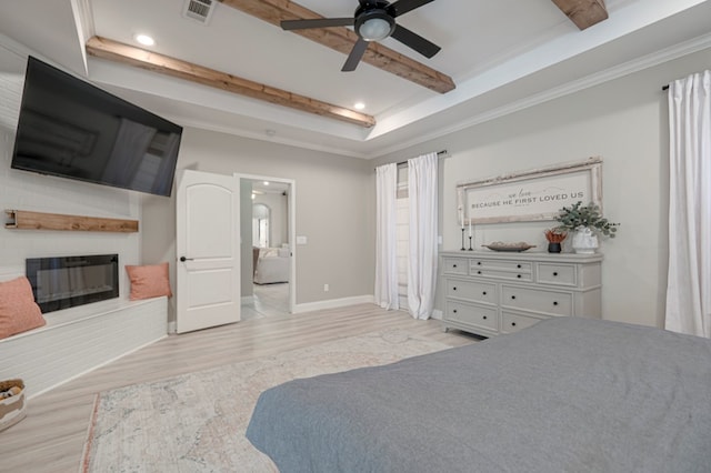 bedroom with a fireplace, visible vents, ornamental molding, light wood finished floors, and beamed ceiling