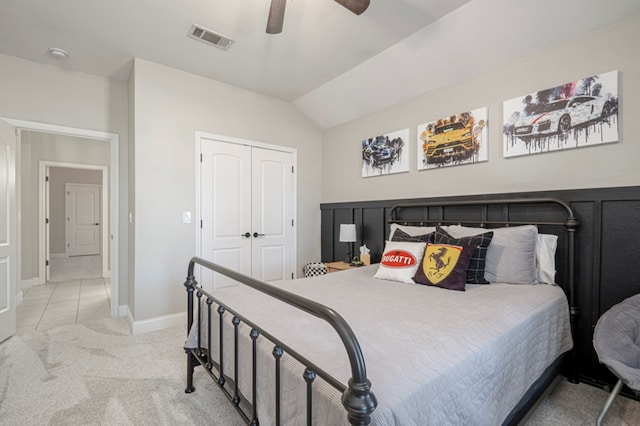 bedroom featuring carpet, a closet, visible vents, a ceiling fan, and vaulted ceiling