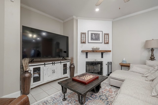 living room with a brick fireplace, ornamental molding, a ceiling fan, and tile patterned floors