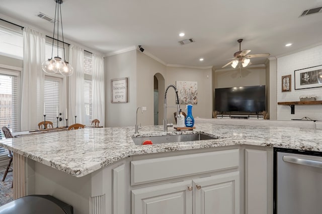 kitchen with ornamental molding, visible vents, a sink, and stainless steel dishwasher