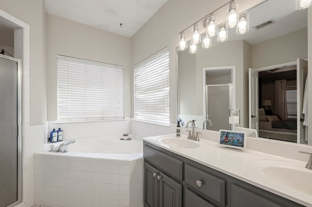 bathroom featuring a bath, a shower stall, visible vents, and a sink