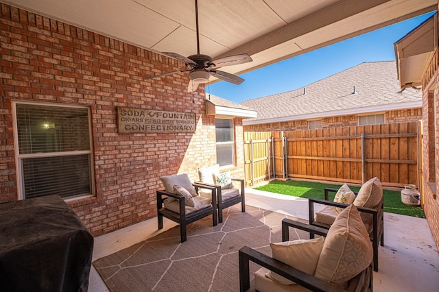 view of patio featuring fence, an outdoor living space, a ceiling fan, and area for grilling