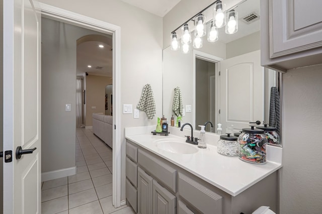 bathroom featuring tile patterned flooring, visible vents, vanity, and baseboards