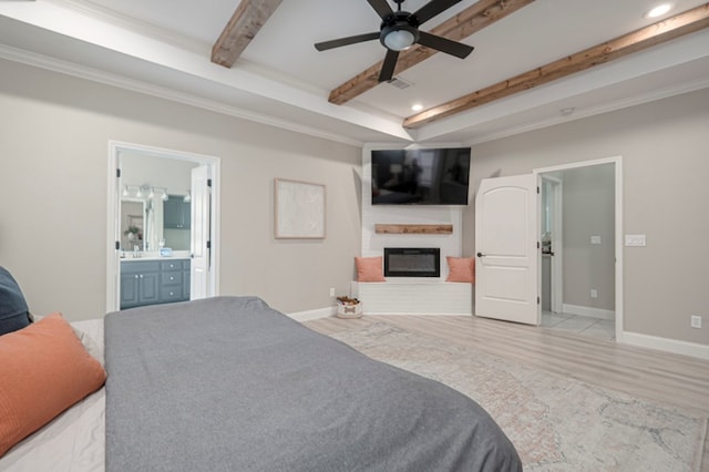 bedroom with a large fireplace, light wood finished floors, visible vents, baseboards, and beamed ceiling