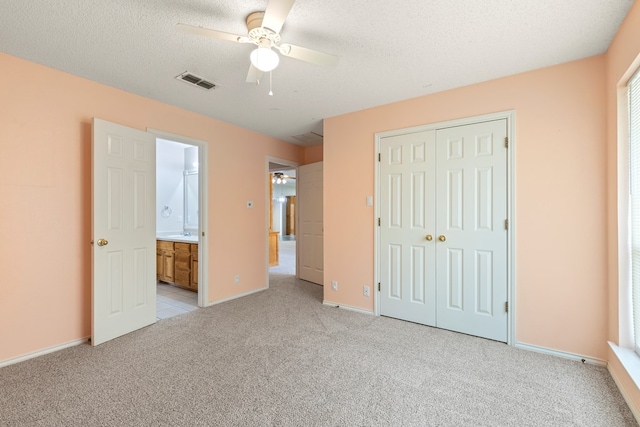 3402 Alicia Ct, Midland, TX 79707 - unfurnished bedroom featuring light carpet, a closet, a textured ceiling, and a ceiling fan