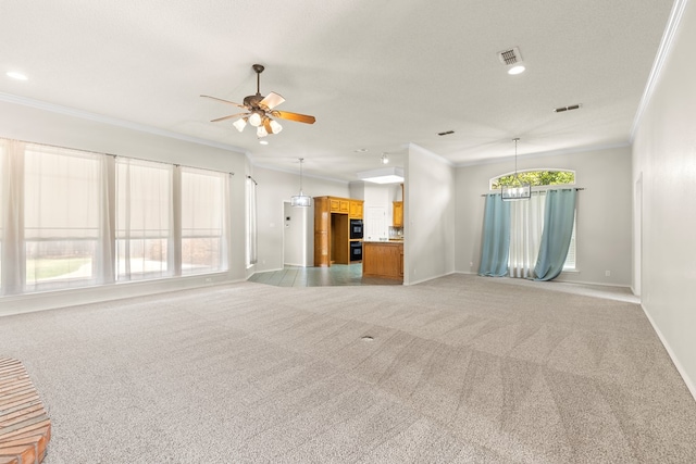 3402 Alicia Ct, Midland, TX 79707 - unfurnished living room featuring ornamental molding, ceiling fan, light colored carpet, a chandelier, and recessed lighting
